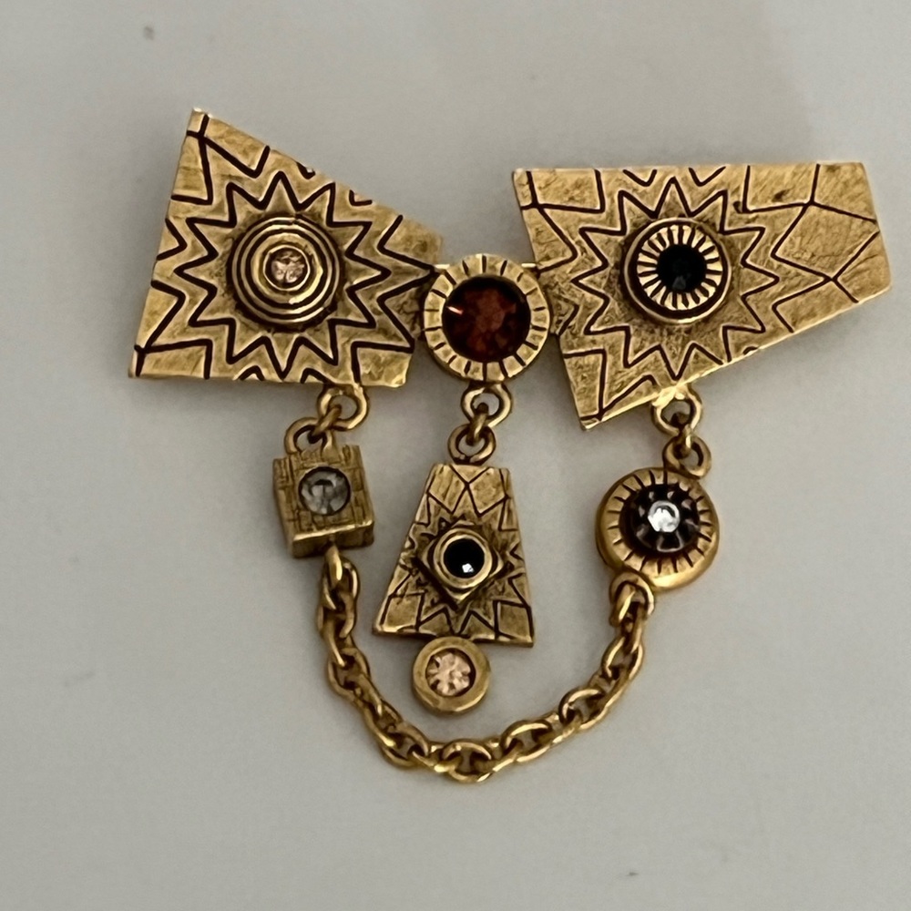 Beautiful gold tone metal pin w/Austrian crystals.  Designed by Patricia Locke.